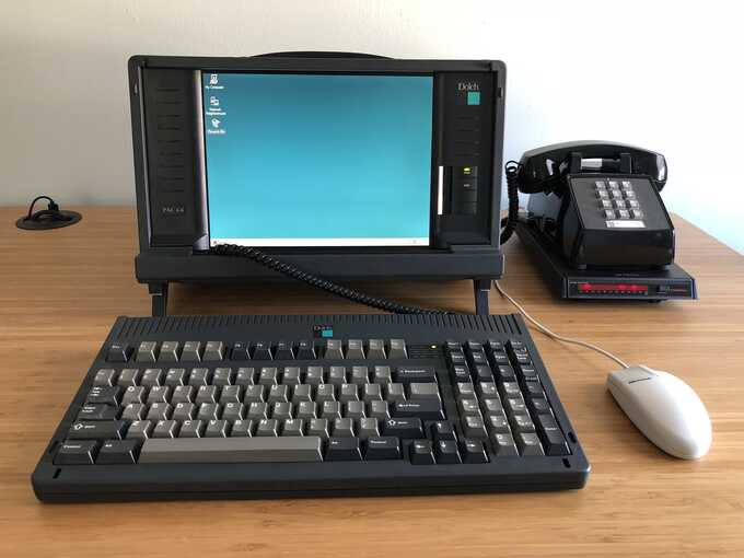 dolch pac booted to windows 95, on desk with keyboard, mouse, and modem