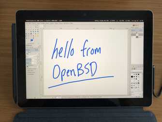 surface go running openbsd with gimp image editor, showing 'hello from openbsd' written in an image on screen